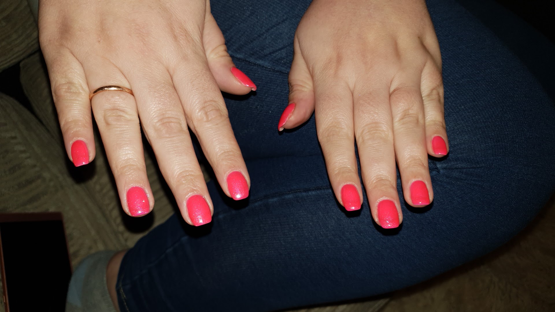 A finished set of bright pink gel nails